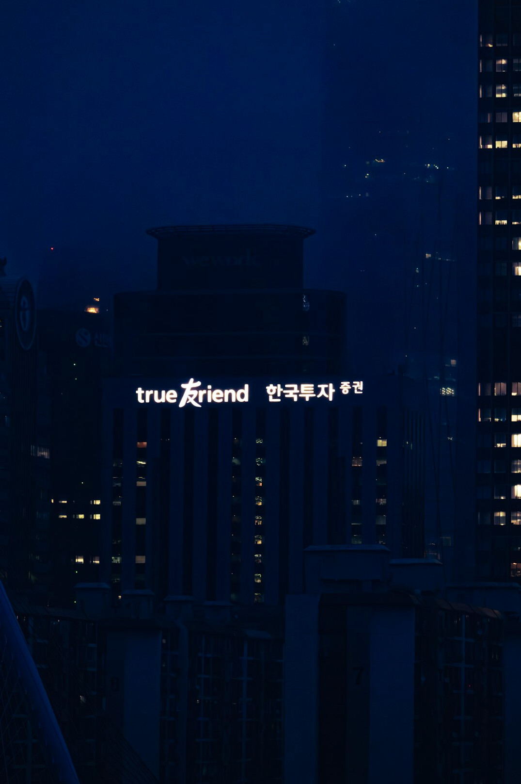 City skyline at night with lit windows