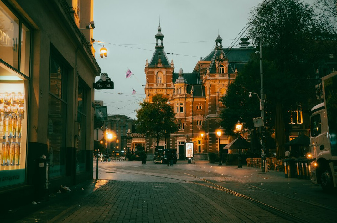 Quiet old city street at dusk with warm lights