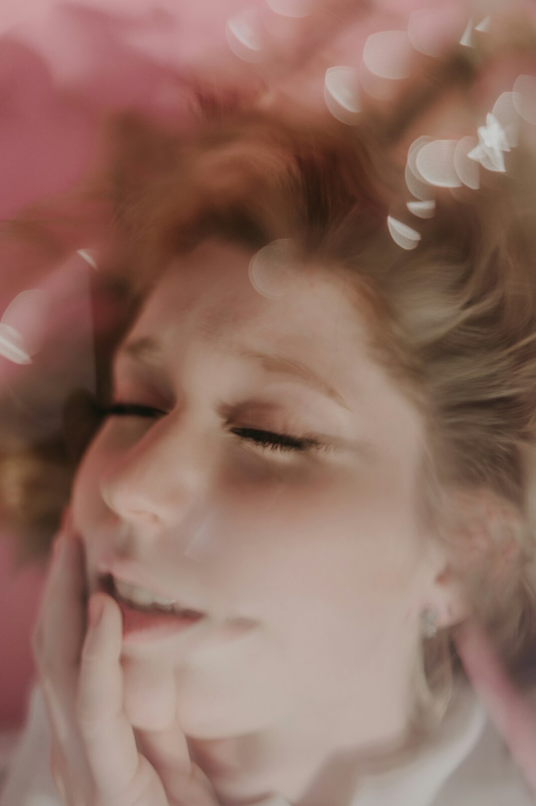 Portrait of a woman with wavy hair smiling softly