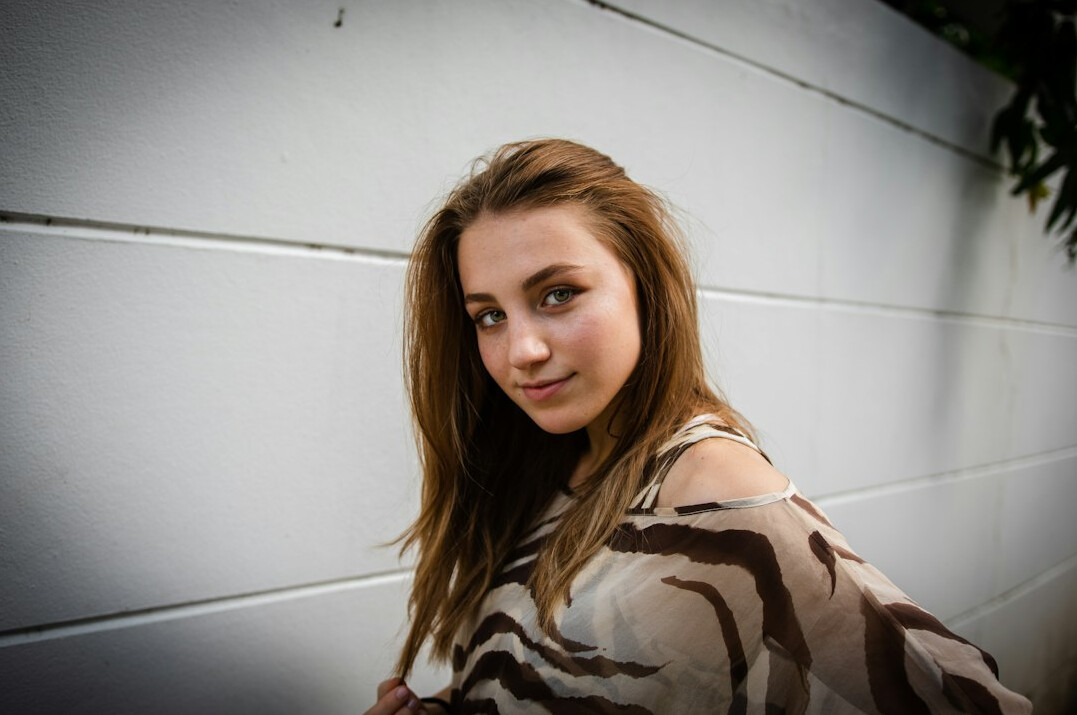 Portrait of a young woman with long hair smiling